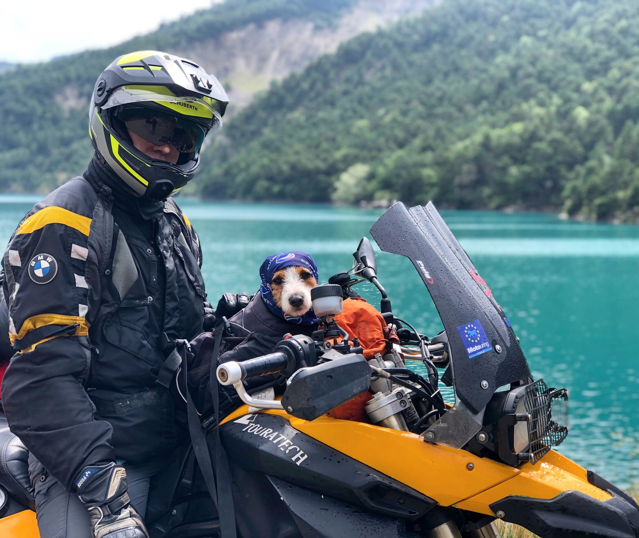 Rodrigo and Jacko beside a motorcycle near a lake